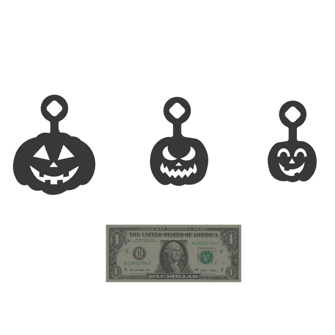 Three jack-o-lantern steel targets in different sizes with loop hangers on top. A U.S. dollar bill is placed below for size reference.